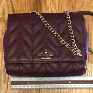 Kate spade mini emelyn briar lane quilted color is deep plumb or burgundy color.